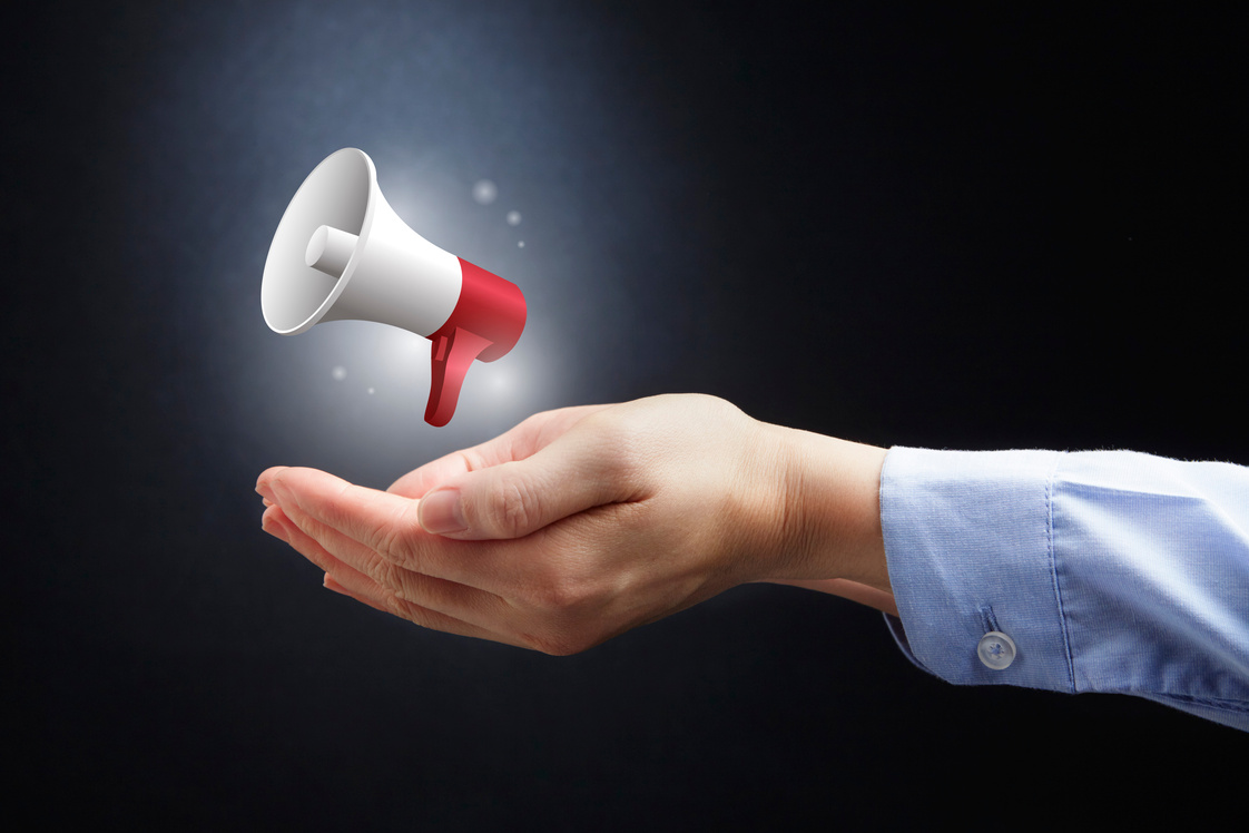 Hands presenting a megaphone